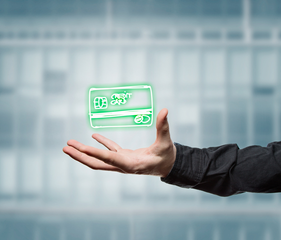Businessman holding a virtual credit card